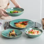 Vancasso KARST green stoneware dinner set with embossed plates and bowls on a rustic wooden table
