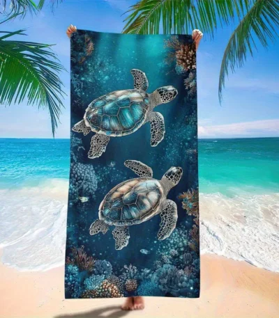 Sea turtle beach towel with vibrant underwater pattern on a sandy beach