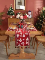 Red and green Christmas table runner with plaid pattern on dining table