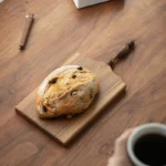 Elegant walnut cutting board with French vintage design, perfect for bread, cheese, and fruit presentation