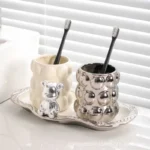 Close-up of electroplated ceramic toothbrush holder showing reflective gold surface and smooth texture.
