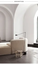 Floor lamp with simple black finish, placed beside a bookshelf in a home office.