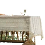 Retro polka dot tablecloth with fringe on a wooden table