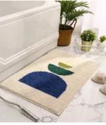 Modern abstract art non slip bathroom rug with vibrant colors and textured surface on a bathroom floor