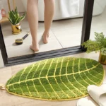 Soft absorbent bath mat in bathroom with banana leaf texture