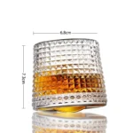 Rotating whiskey glass with wooden base on a bar table