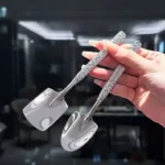 Two stainless steel ice cream spoons with ergonomic handles, one scooping a bowl of vanilla ice cream