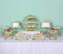 Clear acrylic cake stand displaying a tiered wedding cake with fresh flowers