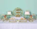 Clear acrylic cake stand displaying a tiered wedding cake with fresh flowers