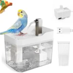 The bird shower fountain in a living room, placed on a shelf with decorative items.