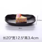 Black melamine dinner plates stacked elegantly on a wooden table