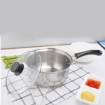 Goldoma stainless steel milk pot with lid on a kitchen stove