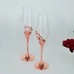 Elegant crystal champagne glasses set on a table with sparkling wine