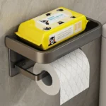 Aluminum alloy tissue rack in modern bathroom, with a single roll and eucalyptus stems.