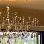 Modern stainless steel chandelier with crystal LED lights in a living room