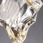 Modern crystal pendant lamp illuminating a dining room with elegant light refraction