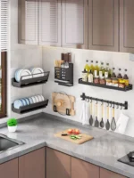 Stainless steel wall mounted dish rack holding plates and bowls in a modern kitchen
