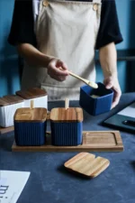 Ceramic kitchen storage container set with matte striped design and spoon