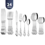 Gold flatware set with spoon, fork, and steak knife on a white tablecloth
