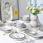 Elegant 20-piece porcelain dinnerware set arranged on a table, showcasing bowls and plates in a gift box