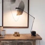 Black floor lamp with sleek metal stem and fabric shade, angled view showing height and proportions.
