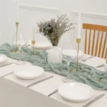 Rustic cheesecloth table runner on wooden table with boho decor