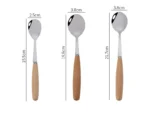 Stainless steel flatware set with wooden handles displayed on a table