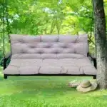 Outdoor bench cushion on a wooden garden bench with vibrant floral pattern