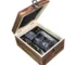 Old fashioned glass set with whiskey tumblers, ice stones, and wooden gift box on a rustic table