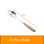 Stainless steel flatware set with wooden handles displayed on a table