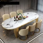 Modern oval marble dining table with gold stainless steel legs seating 6-8 people - Goldoma