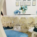 Elegant lace tablecloth with rose gold embroidery on a dining table