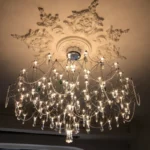 Modern stainless steel chandelier with crystal LED lights in a living room