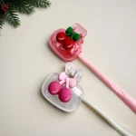 White ceramic holder with cherry pattern, back view showing smooth surface.