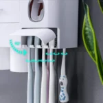 Toothbrush holder with multiple toothbrushes magnetically attached, demonstrating capacity.