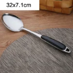 Stainless steel cooking utensils set with spatula, soup spoon, and shovel on a kitchen counter