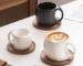 Elegant ceramic coffee mug set with saucer on wooden table, featuring oat-colored cups