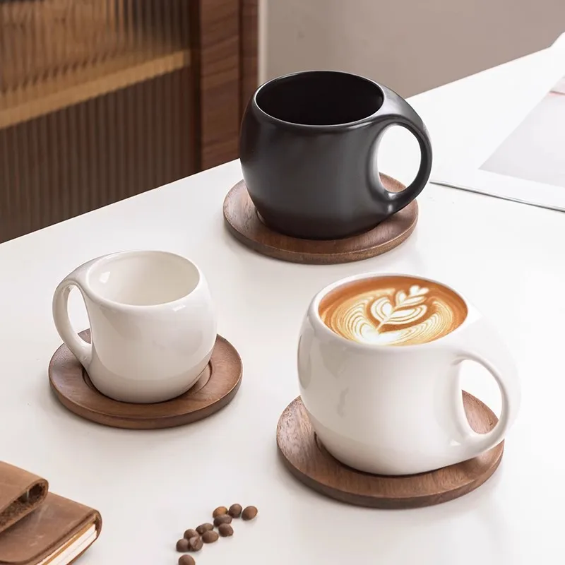 Elegant ceramic coffee mug set with saucer on wooden table, featuring oat-colored cups
