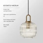 Modern suspension lamp in a dimly lit room, emphasizing the soft glow through the glass shade.