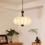 Walnut wood chandelier with fabric shades in a cozy living room