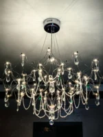 Modern stainless steel chandelier with crystal LED lights in a living room