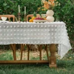 Retro polka dot tablecloth with fringe on a wooden table