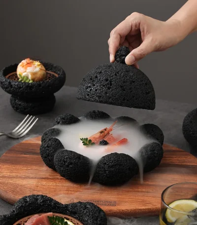 Volcanic stone sushi plate with fresh sushi rolls and wasabi on a dark textured surface