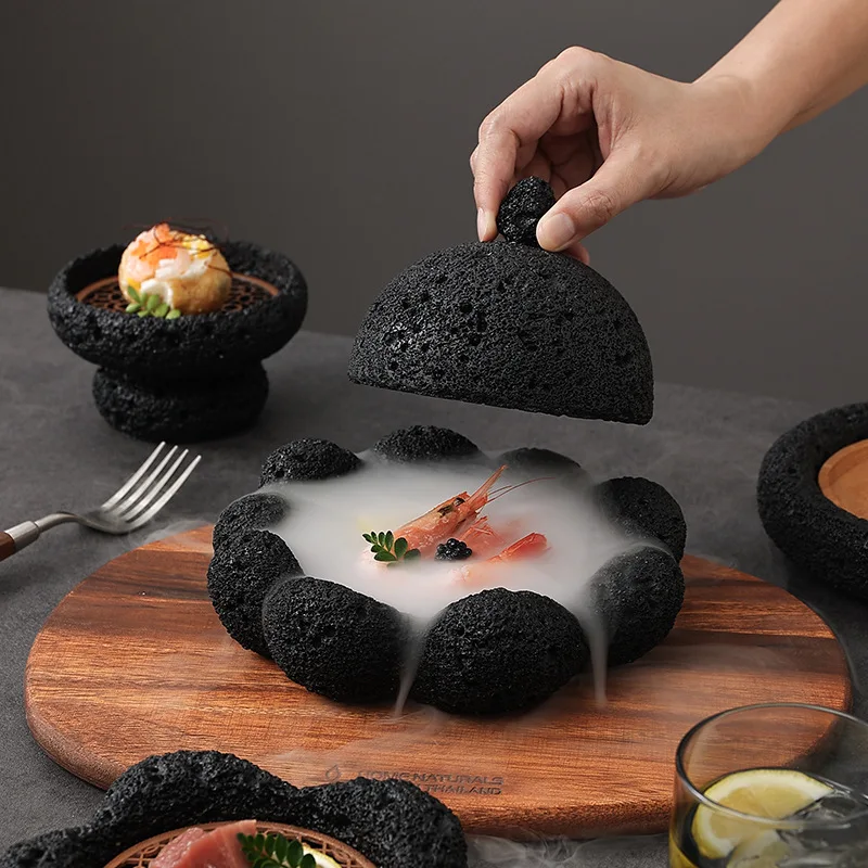 Sb33393fd360844bebb64ce98ae50216bb.webp Volcanic stone sushi plate with fresh sushi rolls and wasabi on a dark textured surface