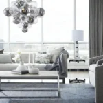 Smoky gray chandelier with glass bubbles hanging over a modern dining table