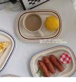 Handcrafted ceramic plates with underglaze floral design on a wooden table