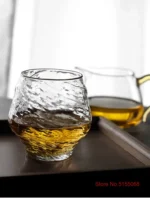 Set of hazy wine glasses with hammer pattern and snowflake design on a wooden table