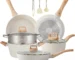 16-piece pots and pans set non-stick cookware with copper-colored exterior and black non-stick interior on a glass stove