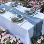 Boho cheesecloth table runner and napkins set as rustic table linens on a wooden table