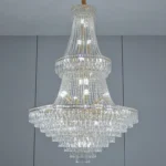 Modern crystal chandelier for dining room hanging over a wooden table with warm glow